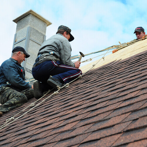 roof installation with roofers working