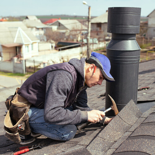 roofer making repairs on a roof